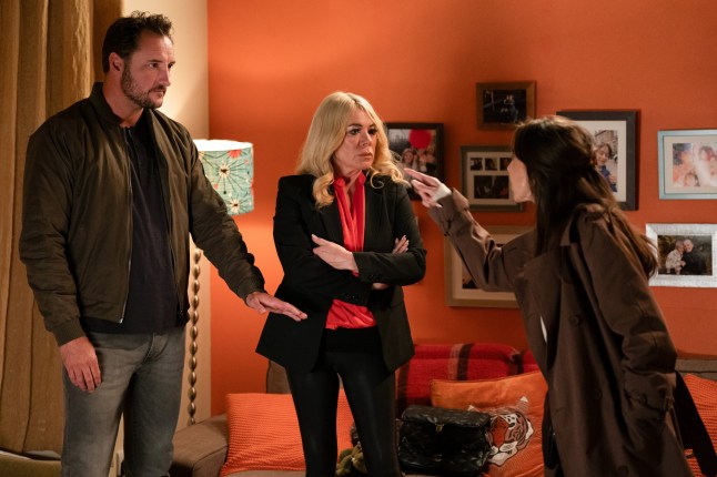 Ruby points at Martin during an argument in EastEnders as Sharon watches on