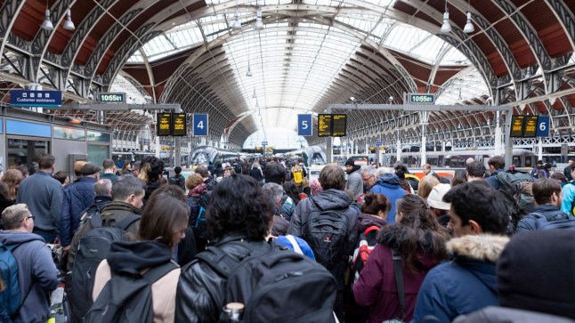 LONDON, ENGLAND - DECEMBER 24: People travel out of the city via train at London Paddington train station on December 24, 2022 in London, England. Rail strikes over the Christmas period have encouraged more people into their cars to make festive journeys by road this year. (Photo by Belinda Jiao/Getty Images)