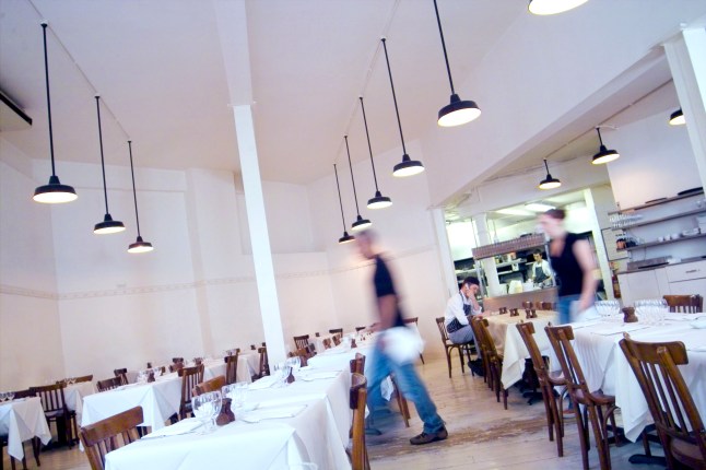 Table settings and staff are seen during preparation for lunch at St John in Smithfield