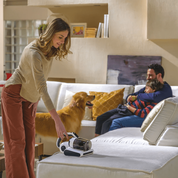 Image of model using Hoover 4-in-1 Corded Handheld UV Mattress Vacuum Cleaner - HMC5