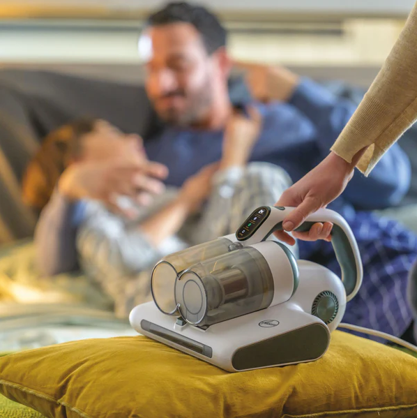 Image of model using Hoover 4-in-1 Corded Handheld UV Mattress Vacuum Cleaner - HMC5