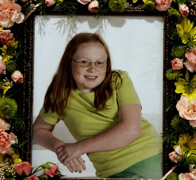 A photo of 10-year-old murder victim Jamie Rose Bolin sits on top of her casket in the high school gymnasium in Purcell, Okla., prior to funeral services, Thursday, April 20, 2006. A neighbor Kevin Ray Underwood, 26, is charged with first-degree murder in the child's death. Authorities described the scene as an elaborate plan to eat human flesh. (AP Photo)