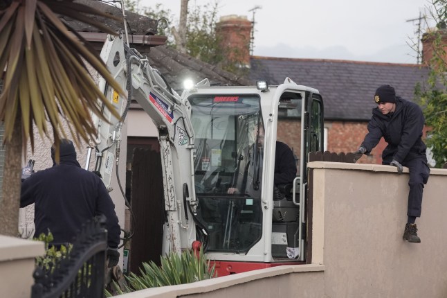 A mechanical digger used by Gardai leaves the area as a search of waste ground continues behind a house in Dundalk, Co Louth, in the investigation into the suspected murder of eight-year-old Kyran Durnin. The former family home, garden and adjoining ground is being searched and will be subject to technical and forensic examinations. An Garda Siochana said the purpose of the search is to discover any evidence which might provide clues to Kyran's whereabouts or what has happened to him. Picture date: Thursday October 24, 2024. PA Photo. See PA story IRISH Durnin. Photo credit should read: Brian Lawless/PA Wire