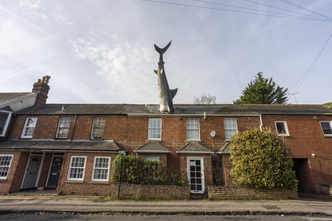 FILE PHOTO - The Shark House in suburban Oxford. Photo released December 16 2024. The owner of the iconic "shark house" in Oxford says "come while you can" after council demand closure of quirky Airbnb.Oxford City Council won the planning appeal banning the use of short let accommodation last week for the quirky property in New Street, Headington, more widely known as the Shark House - which features a 25ft shark sticking out of its roof.This comes after owner Dr. Magnus Hanson-Heine, whose father Bill Heine constructed the sculpture without official planning permission from Oxford City Council in 1986.For the last five years, Dr. Hanson-Heine has been letting the property out on Airbnb for short term stays - but received notice from the council to shut it down, after a member of the public complained about the change from a residential use to a short-term let.