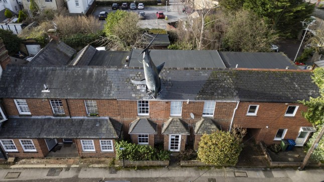 FILE PHOTO - The Shark House in suburban Oxford. Photo released December 16 2024. The owner of the iconic "shark house" in Oxford says "come while you can" after council demand closure of quirky Airbnb.Oxford City Council won the planning appeal banning the use of short let accommodation last week for the quirky property in New Street, Headington, more widely known as the Shark House - which features a 25ft shark sticking out of its roof.This comes after owner Dr. Magnus Hanson-Heine, whose father Bill Heine constructed the sculpture without official planning permission from Oxford City Council in 1986.For the last five years, Dr. Hanson-Heine has been letting the property out on Airbnb for short term stays - but received notice from the council to shut it down, after a member of the public complained about the change from a residential use to a short-term let.