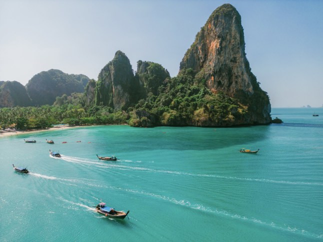 Scenic aerial view of thai taxi boats near the idyllic beach near Railey Beach in thailand