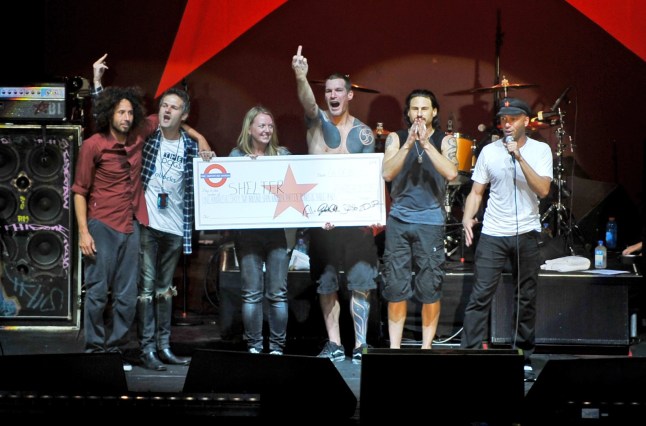 LONDON, ENGLAND - JUNE 06: Facebook campaigners Jon and Tracy Morter receive a donation cheque for the royalties earned for the Christmas 2009 number one single by American rap-rockers Rage Against The Machine during their free concert at Finsbury Park on June 6, 2010 in London, England. (Photo by Andy Sheppard/Redferns)