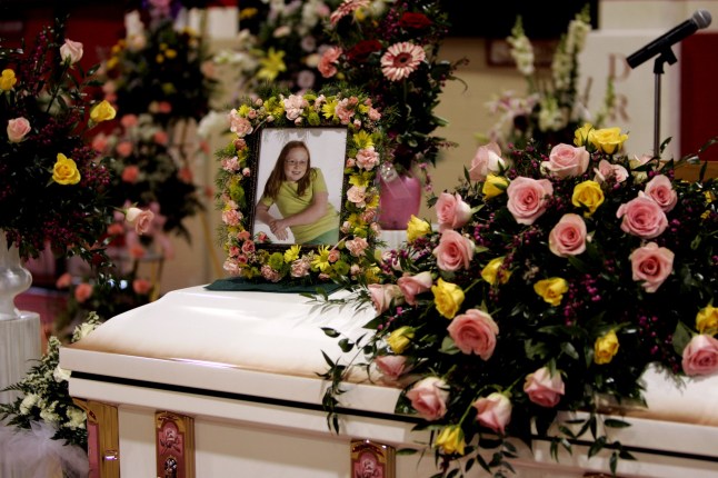 A photo of 10-year-old murder victim Jamie Rose Bolin sits on top of her casket in the Purcell High School gymnasium in Purcell, Okla., prior to funeral services, Thursday, April 20, 2006. Bolin will be buried less than one week after her body was found in the apartment of a man authorities said planned to eat the corpse. Kevin Ray Underwood, 26, is charged with first-degree murder in her death. (AP Photo)